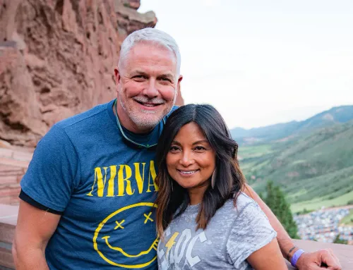 Dr. Christine Nedeau and her husband Joel outdoors on a hillside