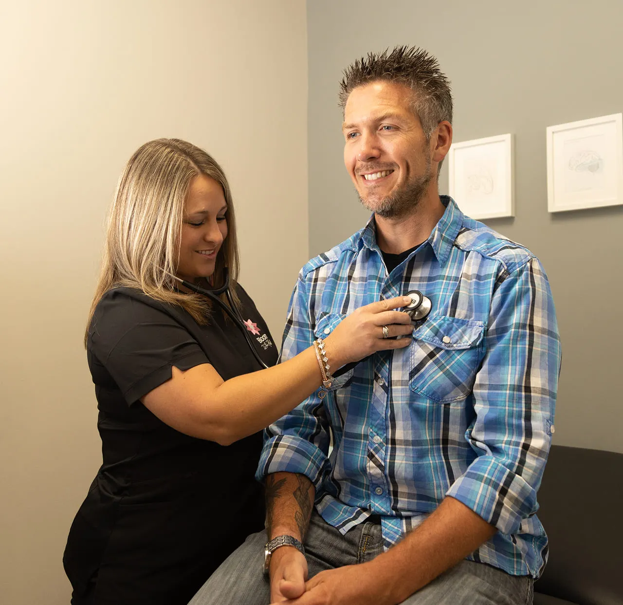 A Bloom nurse checking a patient’s heart with a stethoscope