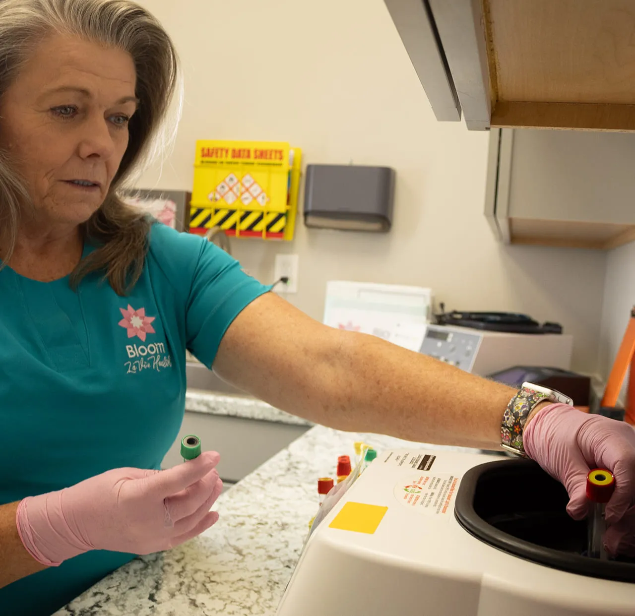 A Bloom La Vie Health team member preparing hormone lab samples at the clinic